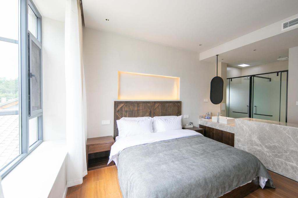 Postel nebo postele na pokoji v ubytování Shan Di B&B