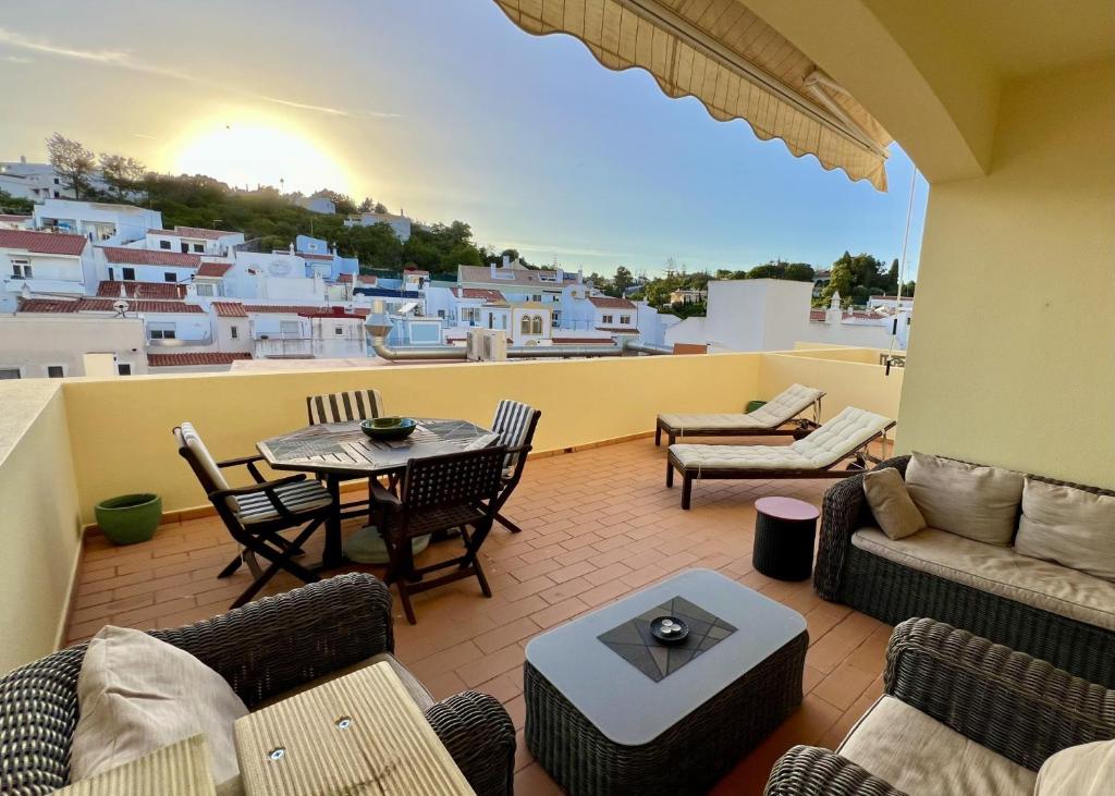 a patio with a table and chairs on a balcony at Carvoeiro terrace - Stay in the heart of Carvoeiro in Carvoeiro