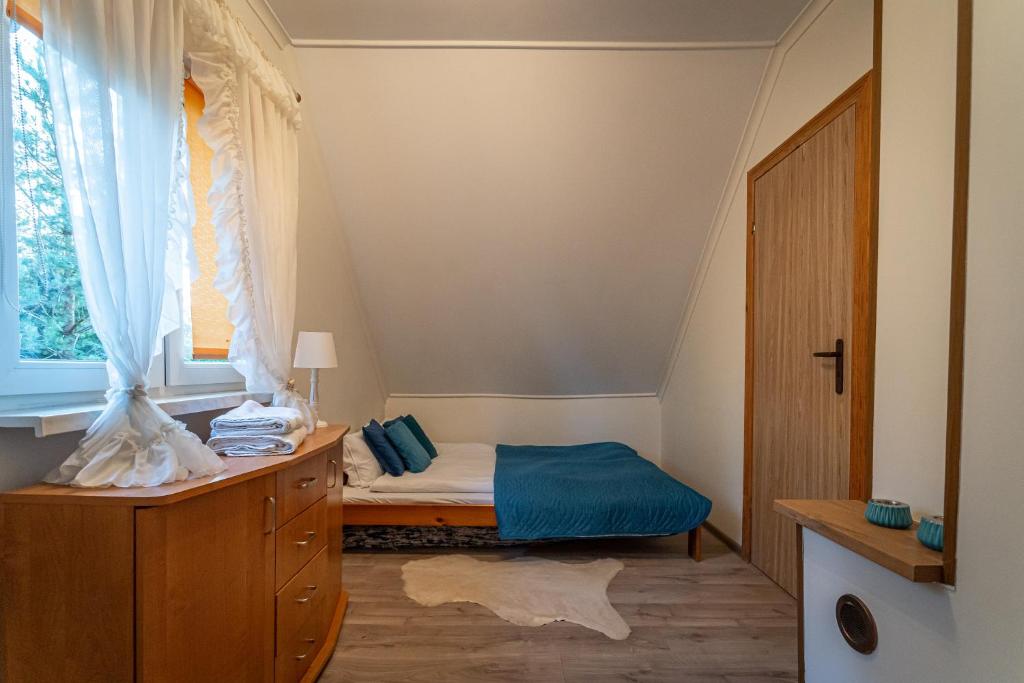 Posteľ alebo postele v izbe v ubytovaní Garden House nad jeziorem Szelment