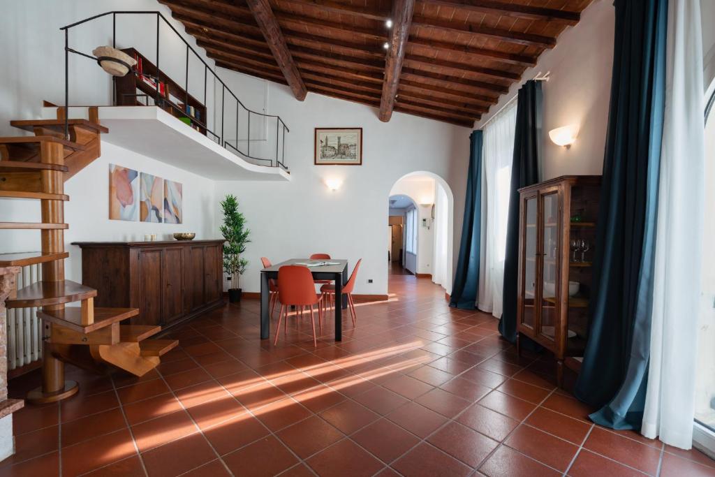a living room with a table and a staircase at Cooker Chianti in Florence