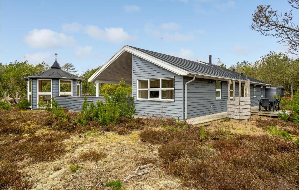 a house on a hill with a yard at Amazing Home In Ålbæk With Sauna in Ålbæk