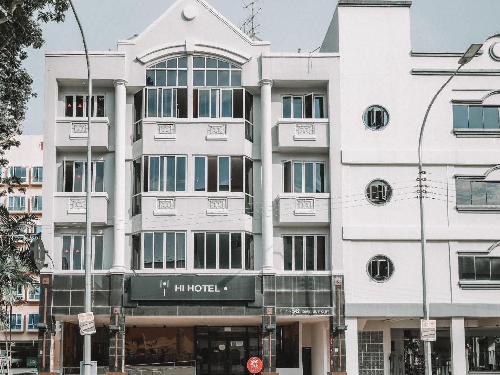a white building with a sign in front of it at Hi Hotel Dot, 11Hrs, Stay from 10PM to 9AM in Singapore