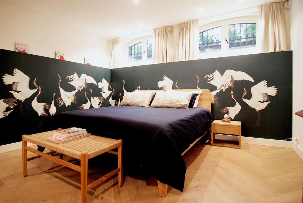 a bedroom with a bed with a black and white wall at Spacious Suite at Park and Museum in Amsterdam