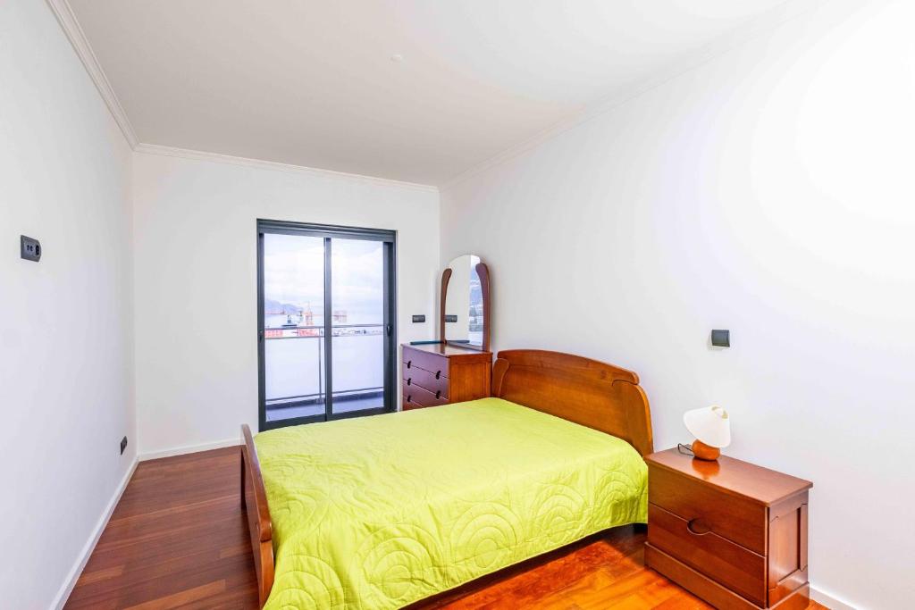 Ένα ή περισσότερα κρεβάτια σε δωμάτιο στο Rooms for Rent in Funchal