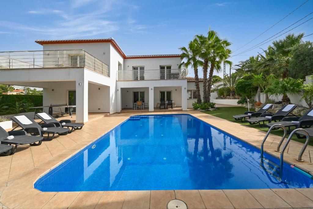 a swimming pool in front of a villa at Villa Angels in Teulada