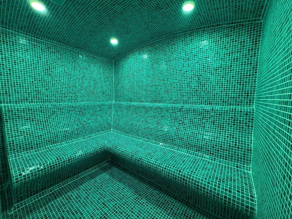 a green room with a tub with green lights at Corfu Hotel in Ayia Napa