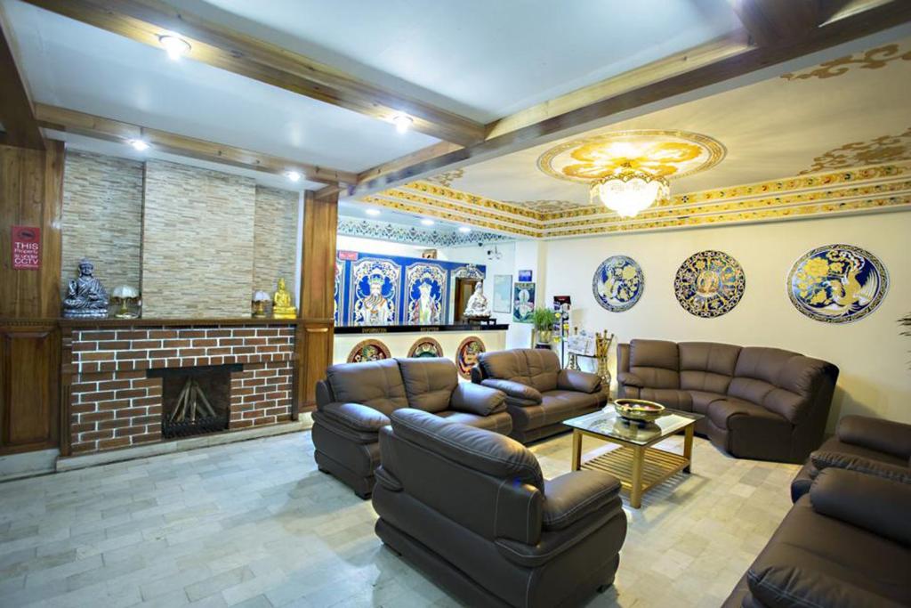 a living room with couches and a fireplace at Central Hill Resort The Mall Road in Gangtok