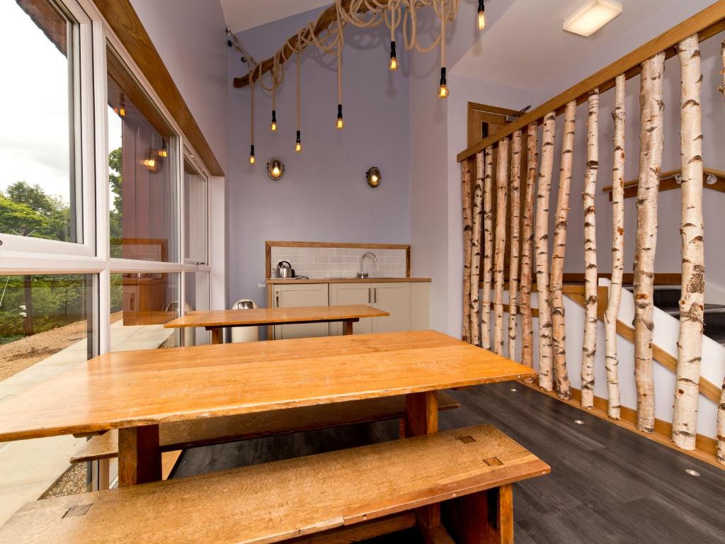 a dining room with a table and benches at YHA Boggle Hole in Fylingthorpe