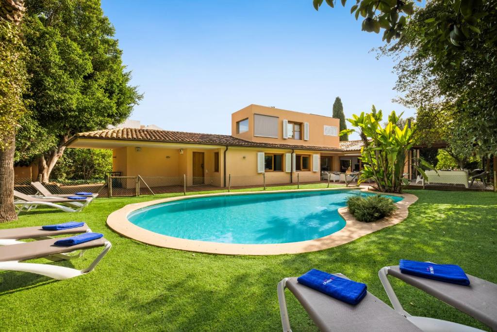 a swimming pool in the yard of a house at Villa Paloma in Palma de Mallorca