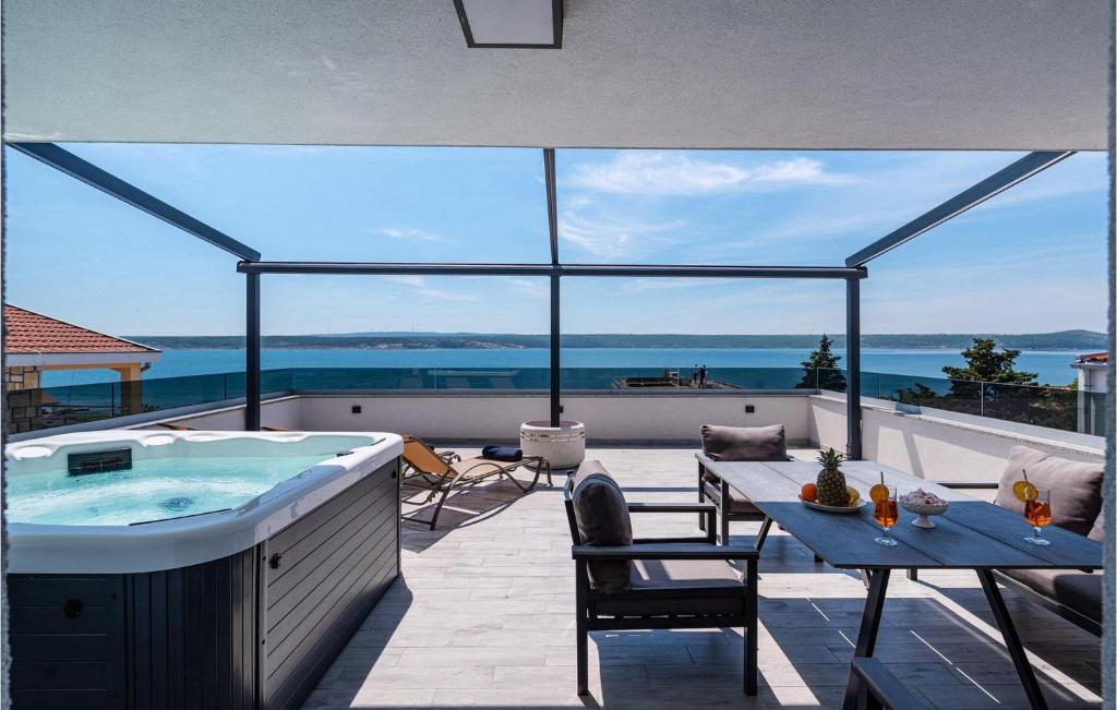 a hot tub on a patio with a view of the ocean at Villa Futura in Zadar