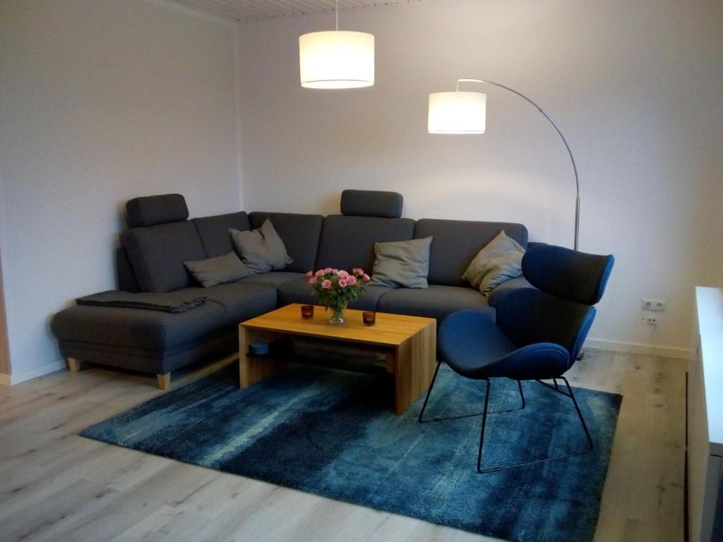 a living room with a couch and a coffee table at Deichblick Süderloog 38 in Spiekeroog