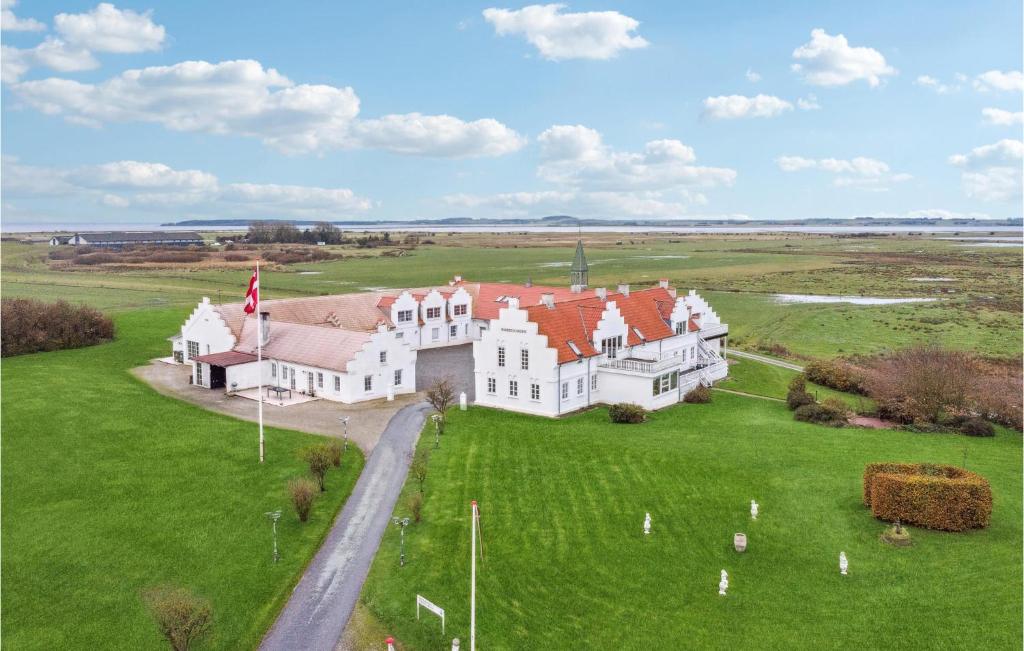 an aerial view of a large white house with red roofs at Bakkegården in Arup