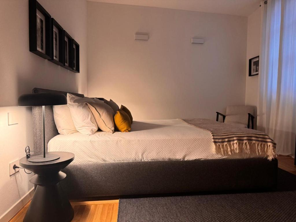 a bedroom with a bed with a yellow pillow on it at La suite in Piazza in Erbusco