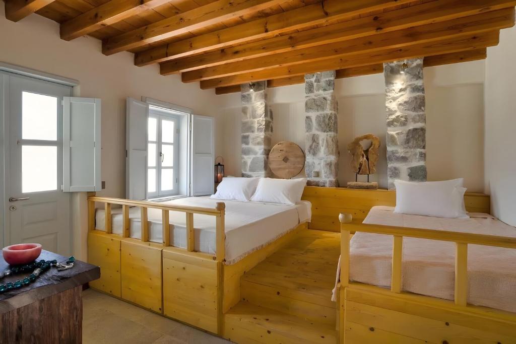 Postel nebo postele na pokoji v ubytování Santanna Suites