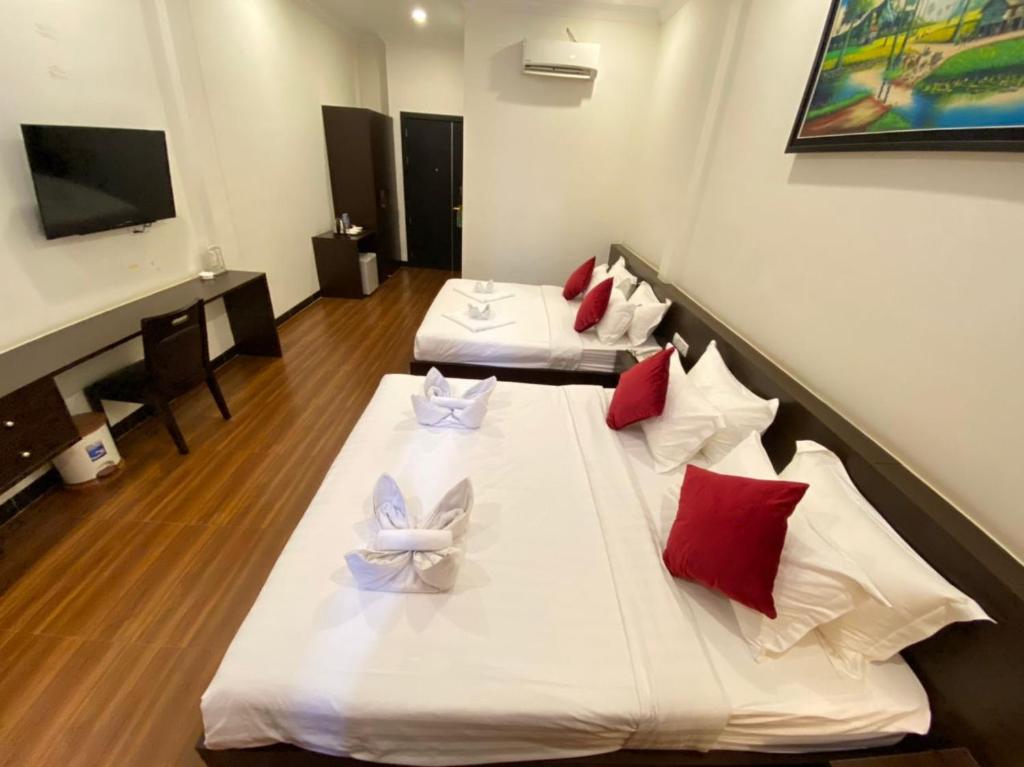 Postel nebo postele na pokoji v ubytování Apple Hotel Two - Near Phnom Penh Airport
