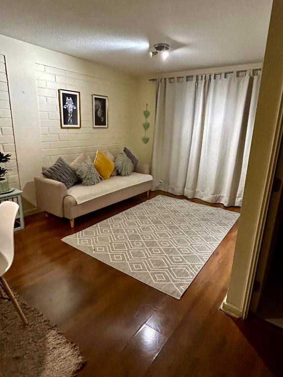 a living room with a couch and a rug at Hotel Boutique "PAQARI" in Vallenar