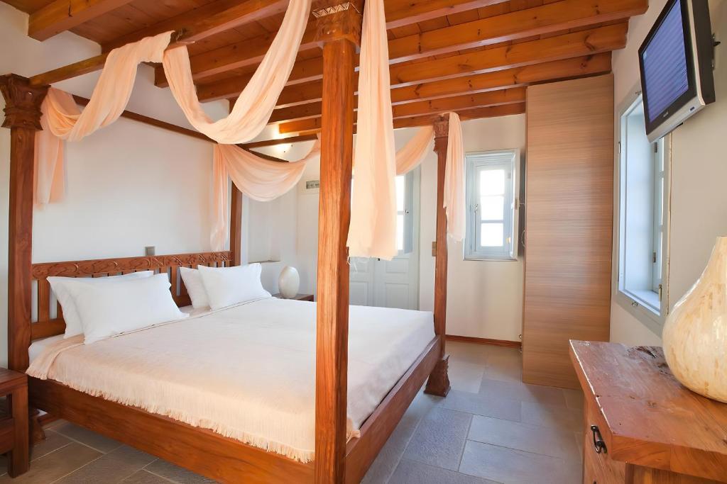 Postel nebo postele na pokoji v ubytování Santanna Suites
