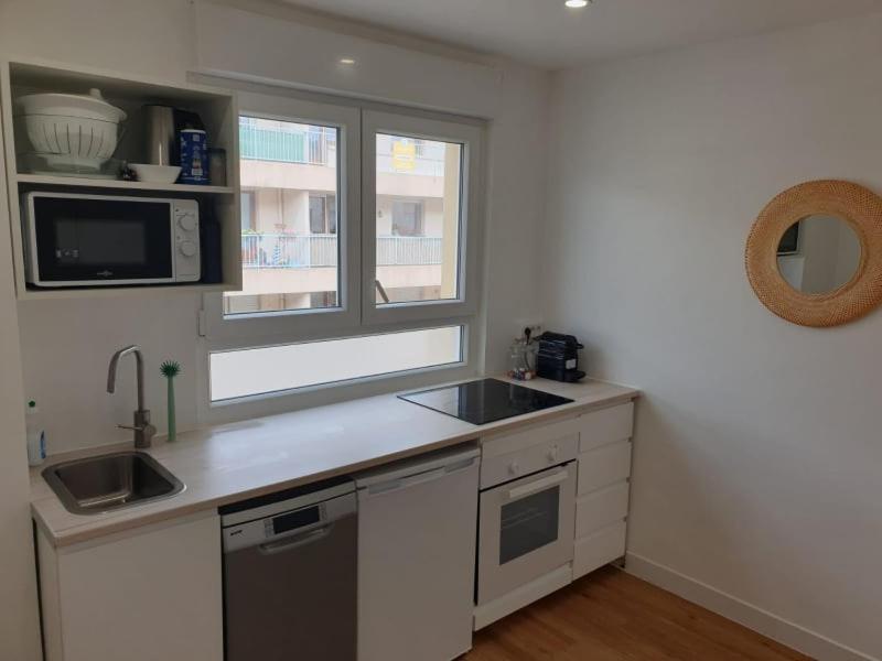 une cuisine avec un évier et un micro-ondes dans l'établissement Le Nid de Metz, à Metz