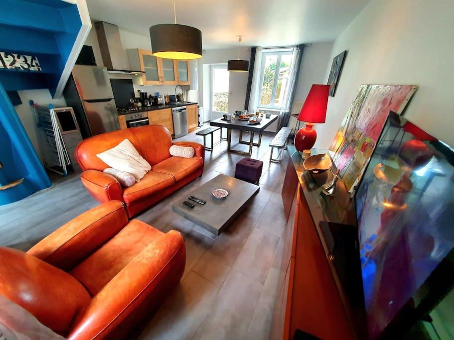 a living room with a couch and a table at La Capitainerie Port du Légué in Plérin
