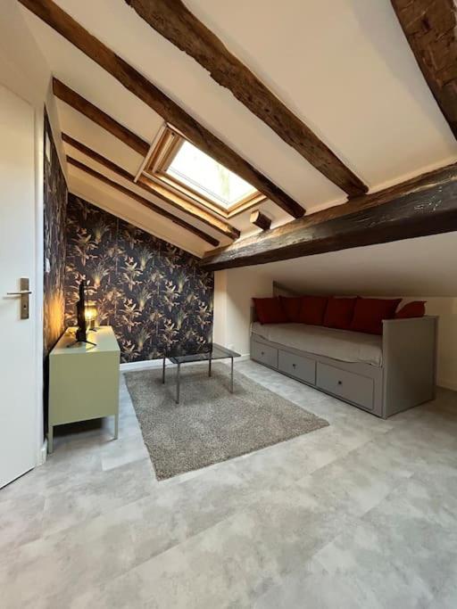 Cette chambre mansardée comprend un lit et une fenêtre. dans l'établissement Le cozy, Jean Jaurès, à Toulouse