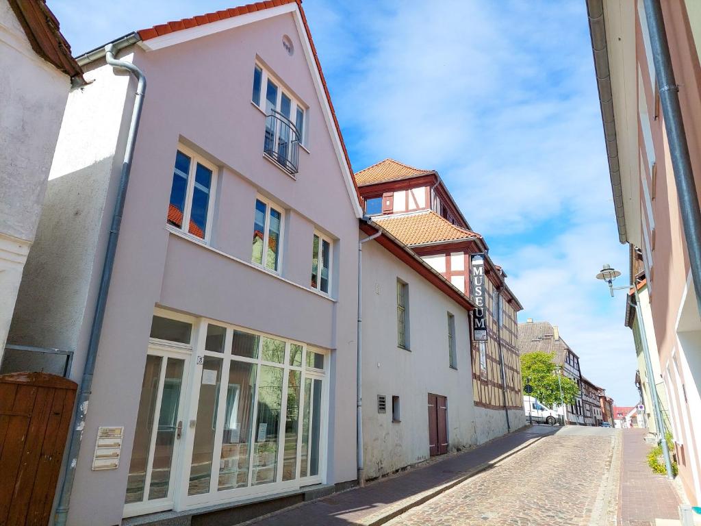 a street in a town with white buildings at Business-Apartments im SCHUSTER-ACHT in Wolgast
