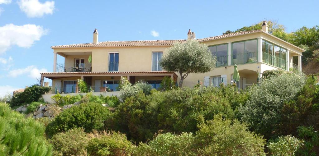 a house on top of a hill with trees at Résidence Casa Régina in Propriano