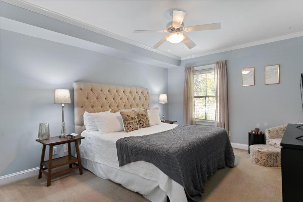 a bedroom with a bed and a ceiling fan at 305 W Taylor Garden in Savannah