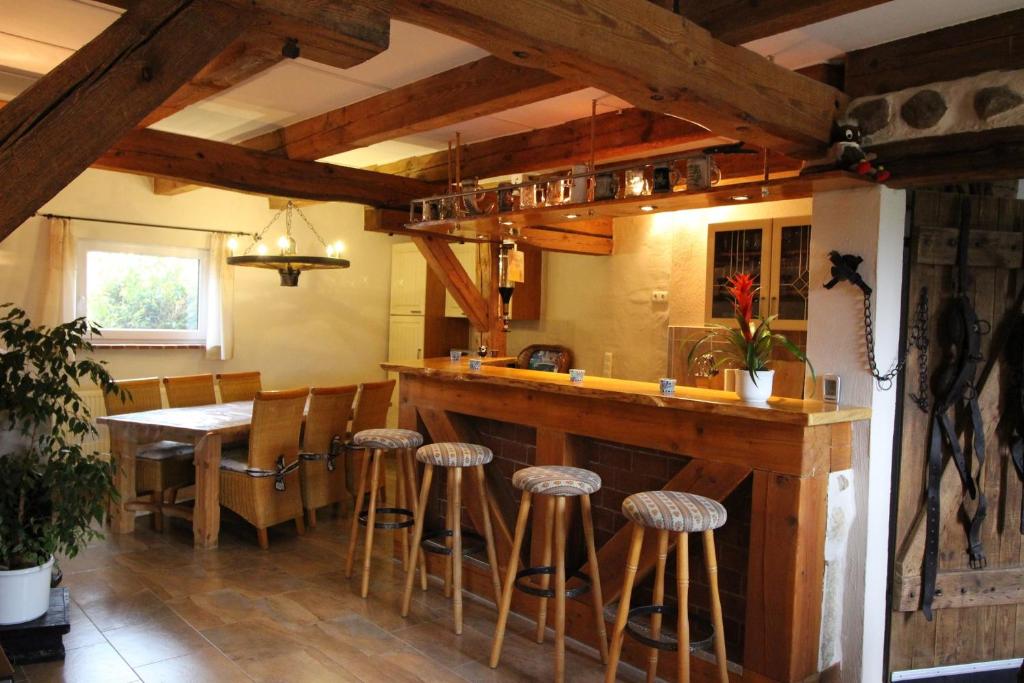 a kitchen with a bar and a table with stools at Ferienwohnungen Zierzow in Zierzow