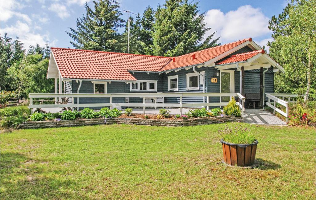 a house with a red roof and a yard at Holiday Home Sletten Hadsund I in Helberskov