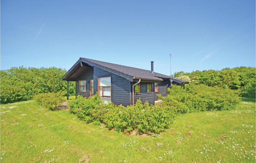 a small house on a hill with a yard at Holiday Home Hellesvej Vestervig Denm in Vestervig