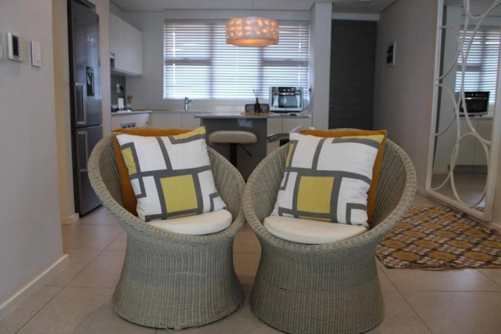 two chairs with pillows sitting in a kitchen at Umhlanga Coastal Chic in Umhlanga
