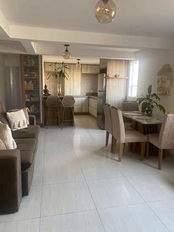a living room with a couch and a table at Villa A with Sea View in Garopaba