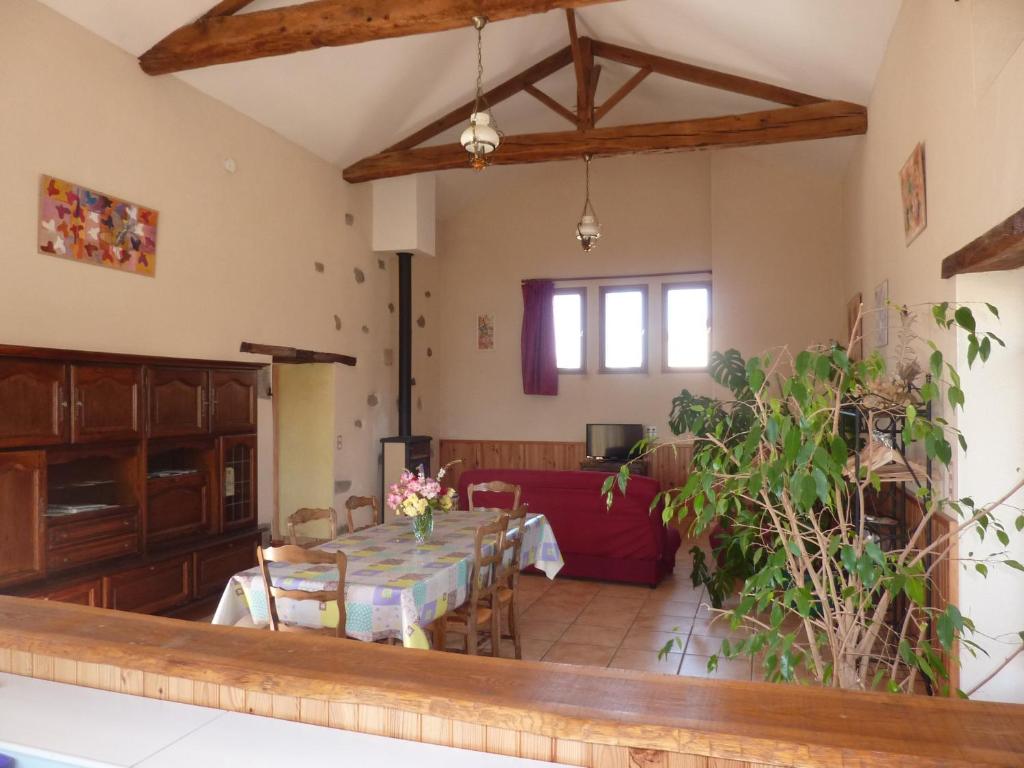 a dining room with a table and a couch at Gîte de l'Ivronnière in La Ronde