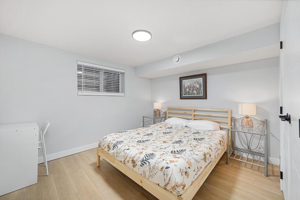 a bedroom with a bed and a window at Flora's House in Calgary