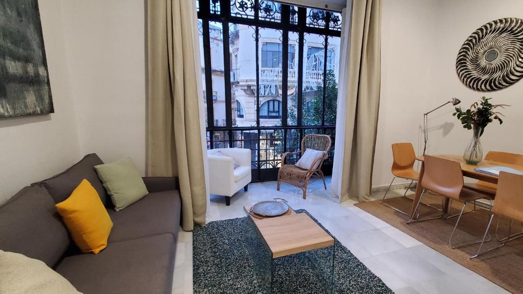 a living room with a couch and a table at Magdalena Plaza City Center 1º in Seville
