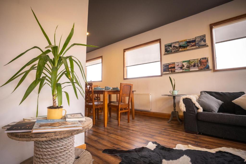 a living room with a couch and a table at Pristine Patagonia Hotel in Puerto Natales