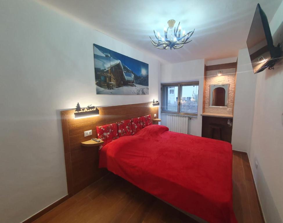 Postel nebo postele na pokoji v ubytování Il RIFUGIO DELLO SCIATORE RESIDENCE PARADISO