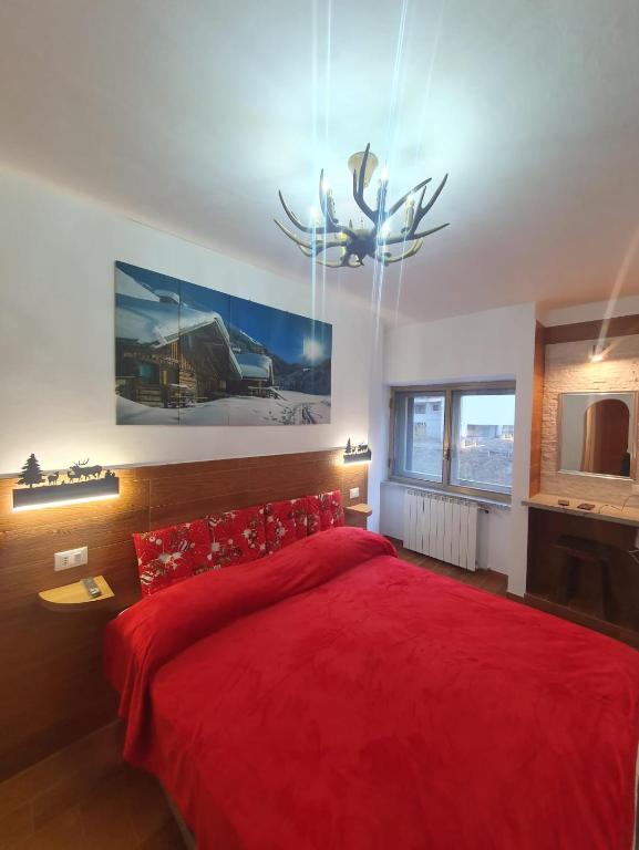 Postel nebo postele na pokoji v ubytování Il RIFUGIO DELLO SCIATORE RESIDENCE PARADISO