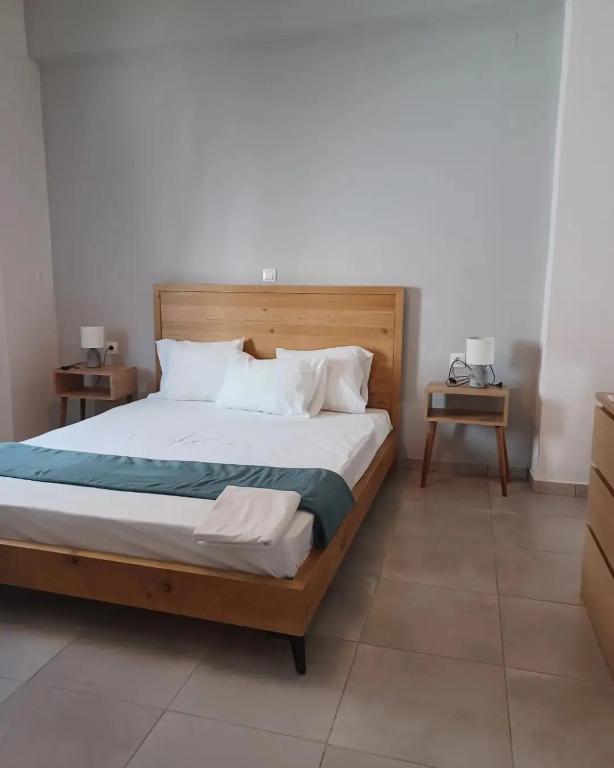 a bedroom with a large bed with a wooden headboard at Petries Apartment in Petriaí