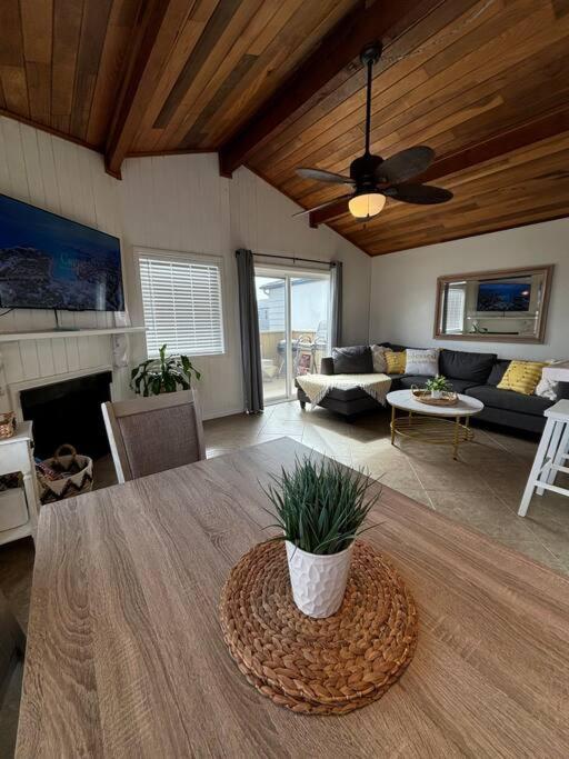 a living room with a table and a couch at Newport Beach Rendezvous in Newport Beach