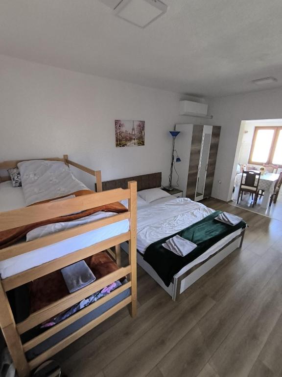 a bedroom with two bunk beds and a table at Mountain House - Brezovica in Brezovicë