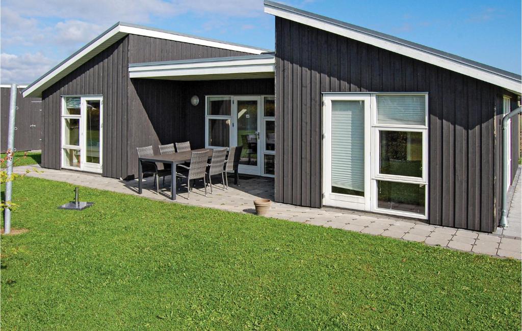 a house with a patio with a table and chairs at Holiday Home Flovt Havevej Vi in Flovt
