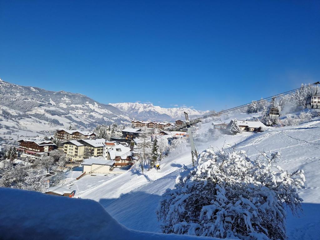 a snow covered mountain with a town in the distance at Ferienhaus Deutschmann in Sankt Johann im Pongau