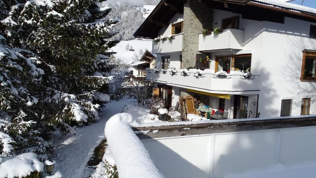 a house in the snow with a fence at Apartment Haus Janine in Westendorf