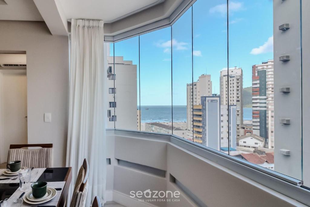 a dining room with a view of the ocean at Apto vista mar a 200m do mar c/ 2 qts BC EBC0603 in Balneário Camboriú