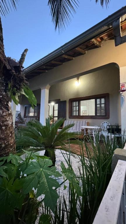 a house with a pond in front of it at LARA'S HOUSE in São Sebastião