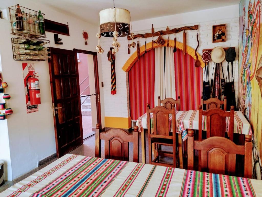 a dining room with a table and a red curtain at La Colorada Hostal in Tilcara