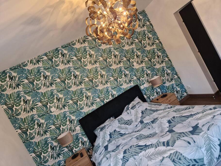 a bedroom with a bed with a table with a bed sqor at appartement avec terrasse in Sillery