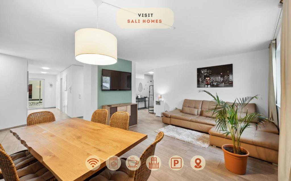 a living room with a table and a couch at Sali Homes - AM2 Spacious Apartment with Terrace in City Center in Bayreuth