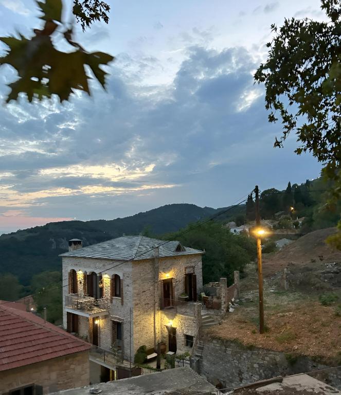 a stone house with a view of a mountain at Αρχοντικό Νόνη in Mileai